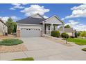 Charming single-Gathering home featuring a covered front porch, well-kept lawn, and attached two-car garage at 22166 E Chestnut Pl, Aurora, CO 80016