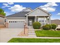 Charming single-Gathering home featuring a covered front porch, well-kept lawn, and attached two-car garage at 22166 E Chestnut Pl, Aurora, CO 80016