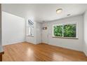 Bright living room with hardwood floors, large windows, and ample natural light at 584 Ridgeview Dr, Louisville, CO 80027