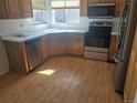 Well-lit kitchen features wood cabinets, stainless steel appliances, and laminate countertops at 2786 E 118Th Cir, Thornton, CO 80233