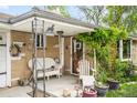 Inviting front porch with seating area, potted plants, and charming decor for a welcoming entrance at 9045 W Ithaca Pl, Denver, CO 80235
