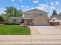 Traditional two-story home featuring a well-maintained front yard and attached garage at 3138 E Otero Cir, Centennial, CO 80122