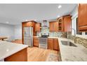 Modern kitchen with stainless steel appliances, wood cabinets, and marble countertops at 13424 Virgo Dr, Lone Tree, CO 80124