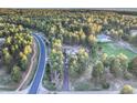 Expansive aerial shot showcasing the property nestled within a lush forest, highlighting privacy and natural beauty at 18330 Archers Dr, Monument, CO 80132