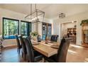 Elegantly designed dining room with a modern chandelier, large windows, and hardwood floors, perfect for entertaining at 18330 Archers Dr, Monument, CO 80132