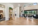 Inviting living room featuring a stone fireplace, hardwood floors, and seamless transition to the outdoors at 18330 Archers Dr, Monument, CO 80132
