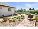 Backyard featuring stone landscaping and a walkway, a seating area and mature plants at 3450 N Harrison St, Denver, CO 80205