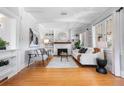 Bright living room featuring hardwood floors, a fireplace, and built-in bookshelves at 1065 Jackson St, Denver, CO 80206