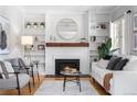 Bright living room featuring hardwood floors, a fireplace, and built-in bookshelves at 1065 Jackson St, Denver, CO 80206