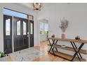 Welcoming foyer with decorative console table and grand front door with beveled glass accents at 897 E Rim Rd, Franktown, CO 80116