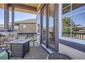 Cozy covered porch with stylish seating, perfect for outdoor relaxation and entertaining at 23960 E Easter Pl, Aurora, CO 80016