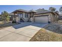 Inviting home showcasing a stone-accented facade, covered porch, and a spacious driveway at 23960 E Easter Pl, Aurora, CO 80016