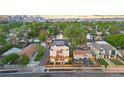 Wide aerial shot of townhomes in a neighborhood, showcasing proximity to urban skyline and green spaces at 1048 Knox Ct, Denver, CO 80204