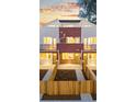 Townhome exterior showcasing individual entrances and privacy fences at dusk at 1048 Knox Ct, Denver, CO 80204