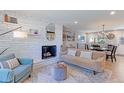 Inviting living room featuring a stone accent wall fireplace, plush seating, and an open floor plan at 2337 S Franklin St, Denver, CO 80210