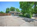 Expansive driveway providing ample parking space and leading to a detached garage at 892 S Union Blvd, Lakewood, CO 80228