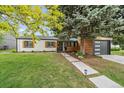 Well-kept single Gathering home with mature trees and landscaping in front yard at 2865 S Cherry Way, Denver, CO 80222