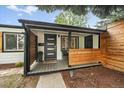 A modern style porch with privacy screening and a cozy seating area at 2865 S Cherry Way, Denver, CO 80222
