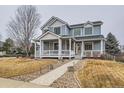 Charming two-story home with a welcoming front porch and landscaped walkway at 3063 E 148Th Pl, Thornton, CO 80602