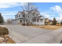 Two-story home featuring a large driveway and a welcoming front porch at 3063 E 148Th Pl, Thornton, CO 80602