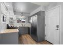 Bright kitchen showcases gray cabinets, stainless steel appliances, modern countertops, and a convenient door to the outside at 16120 E Radcliff Pl, Aurora, CO 80015