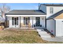 Inviting front porch with two wooden chairs, creating a welcoming entryway at 12293 W Saratoga Ave, Morrison, CO 80465