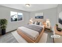 Inviting bedroom with a large window, stylish decor, and a comfortable bed at 4548 Quandary Peak St, Brighton, CO 80601