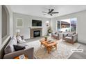 Cozy living room featuring a stone fireplace, plush seating, and ample natural light at 4548 Quandary Peak St, Brighton, CO 80601
