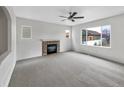 Bright living room with plush carpet, large window and a fireplace to make it cozy at 4548 Quandary Peak St, Brighton, CO 80601