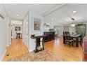 Open-concept living and dining area with hardwood floors and decorative lighting at 3807 S Jasmine St, Denver, CO 80237