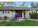 Close up view of the front entrance and manicured flower bed at 3807 S Jasmine St, Denver, CO 80237