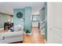 Inviting living space featuring hardwood floors, tasteful decor, and seamless transition to other rooms at 6071 S Ingalls St, Littleton, CO 80123