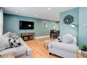 Bright living room with hardwood floors, comfortable seating, and an open layout, ideal for entertaining at 6071 S Ingalls St, Littleton, CO 80123