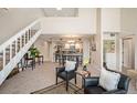Open-concept living room boasts two-story ceilings, a staircase, and an open flow into the dining and kitchen areas at 23585 Genesee Village Rd # E, Golden, CO 80401
