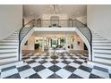Grand foyer with a black and white checkered floor, a split staircase, and views into other living spaces at 4736 S Fillmore Ct, Cherry Hills Village, CO 80113