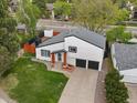 Aerial view of home featuring a manicured lawn, two-car garage, and natural wood porch supports at 4484 S Granby Ct, Aurora, CO 80015