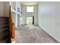 Bright living room with tall ceilings and a large window letting in natural light at 2033 Espana Way, Aurora, CO 80011