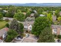 An aerial view showcasing a residential area with lush greenery and mountain views at 3086 W 107Th Pl # F, Westminster, CO 80031