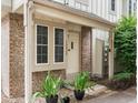 Inviting townhome entrance with a brick facade, potted plants, and a charming front door at 3086 W 107Th Pl # F, Westminster, CO 80031