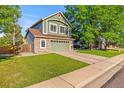 Charming two-story home with a well-maintained lawn and an attached two car garage at 14712 Josephine St, Thornton, CO 80602