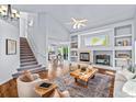 Open-concept living area with a fireplace and hardwood floors throughout at 14712 Josephine St, Thornton, CO 80602