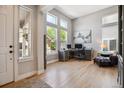 Bright office space with hardwood floors, large windows, and modern furnishings, perfect for working from home at 3102 Fox Sedge Pl, Highlands Ranch, CO 80126