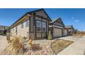 Charming exterior with neutral siding, rock landscaping, and a well-maintained lawn at 11926 Barrentine Loop, Parker, CO 80138