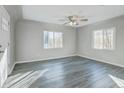 Inviting living room featuring updated gray flooring and a modern ceiling fan at 1437 N Uinta St, Denver, CO 80220