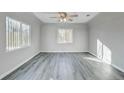 Bright living room with large windows and stylish gray wood flooring at 1437 N Uinta St, Denver, CO 80220