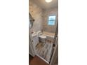 Well-lit bathroom featuring tiled walls, a white vanity, toilet, and a shower-tub combination at 2880 W 91St Pl, Denver, CO 80260