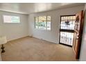 Bright living room with fresh paint, carpet flooring, and two windows that allow ample natural light at 660 Wolff St, Denver, CO 80204