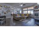 Spacious living room with a large sectional sofa, fireplace, and hardwood floors at 12254 Hazel Spruce Ct, Parker, CO 80134