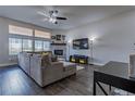 Cozy living room with hardwood floors, fireplace, and a large window at 12254 Hazel Spruce Ct, Parker, CO 80134