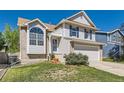 Beautiful two-story home with blue shutters, a well-maintained lawn, and an attached two-car garage at 13069 Jackson Dr, Thornton, CO 80241